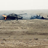 Still burning, these two Iraqi T-55 main battle tanks were damaged by a Coalition attack near the Kuwait border during Operation Desert Storm. The rear tank was attempting to tow the other one, as evidenced by the cable linking them, February 1991.
Watch