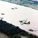 A Douglas A-1E, an A-1H/J Skyraider, a Lockheed HC-130P Hercules recovery aircraft as well as a refueling a Sikorsky HH-3E Jolly Green Giant helicopter form part of a U.S. Air Force air rescue team in Vietnam, 1968.