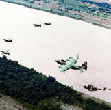 A Douglas A-1E, an A-1H/J Skyraider, a Lockheed HC-130P Hercules recovery aircraft as well as a refueling a Sikorsky HH-3E Jolly Green Giant helicopter form part of a U.S. Air Force air rescue team in Vietnam, 1968.