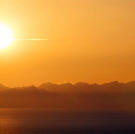A warm evening sun shines across the bay, as daylight nears its end.