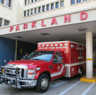 A fire truck sits outside Parkland Hospital Emergency and Trauma.