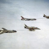 Two A-4F Skyhawks refuel a pair of RF-8G Crusaders in the early 1970s.