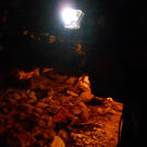 Turtleman’s (Ernie Brown, Jr.) silhouette shows how dark the cave is as he searches for the trapped critter.
