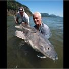 Jeremy Wade with a white sturgeon, the largest and most primitive freshwater fish in North America. The biggest white sturgeon on record stretched more than 20 feet in length and weighed almost 1,800 pounds.