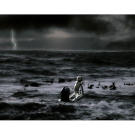 The mother holds her new born out of the water as it takes its first breath.