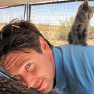 John gives a wee little kitten a boost.