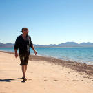 Les Stroud walks on a beach on Tiburon Island looking for items to salvage.