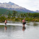 Stripped to their skivvies, the pair wade through a frigid river with their clothes high and dry. Brief pain is much better than the threat of hypothermia that comes with soaked clothing.