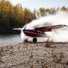 Jim catches a little water as he touches down on a remote, wilderness riverbed. Landing on sandbars, glaciers and ridge tops is Jim's specialty and a major source of income.