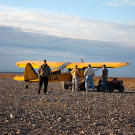 A pilot helps passengers unload at the Kavik River Camp, a remote northern settlement not far from Deadhorse, Alaska.