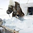 A Dolgan melts ice to obtain fresh water.