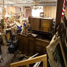 Before an auction, Gallery 63 is floor-to-ceiling stuff, everything from paintings and jewelry to rugs and vampire-killing kits.