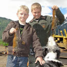 Hudson and Hunter Hoffman with freshly-caught squirrels that they'll skin and roast on their own.