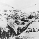 A line of prospectors begin their ascent toward the Chilkoot Pass that will take them over the border into Canada. Heavy snows in the fall of 1897 did little to stem the tide of fortune-seekers. Most of the arrivals were ill-prepared for what lay ahead as suggested by the fellow carrying a canoe on his back. Another carries a cumbersome crate labeled "Dyea" for the Alaskan town where many picked up supplies before heading out.
Few of the thousands who set out had any skill at gold prospecting. Likewise, hardly any carried sufficient supplies so that over the next months the greatest danger facing the Klondike miners was famine.