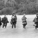 A group of actresses crosses the Dyea River in Alaska heading for one of the new boom towns. The larger settlements featured theaters that usually played to large male audiences hungry for entertainment.