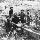 A mining crew displays a large gold nugget recovered from one of their sluices. Such finds were extremely rare and most miners were lucky to find a few ounces of hard-won dust.