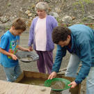 Grandma Erma looks on as young Parker and family friend Sam McPhetres do some panning at Big Nugget. Some of Parker's earliest memories are the summers he spent at Big Nugget with his Grandpa.