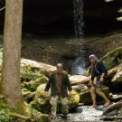 Dave takes the lead as the pair survey their latest survival location since these Kentucky woodlands are much the same as Dave's home turf in the temperate forests of eastern Ohio. Warmth and shelter are always the big firsts but Dave has an edge up with local food options, especially mushrooms, berries and other edible plants.