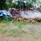 Veteran driver Danny Pelletier narrowly escapes death when his truck rolls on a back logging road.