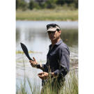 Mykel prepares a water lilly root for eating.