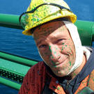 Mike Rowe helps maintain the Mackinac Bridge, which included giving it — and his face — a fresh coat of green paint.