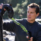 Bear Grylls holds up his dinner, an eel that he lured with a piece of whale carcass and then caught with flax, an ancient Maori fishing technique.