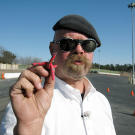Jamie Hyneman shows off the tire spikes used to thwart a pursuing vehicle in Spy Car Escape.