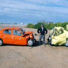 Is the force of two cars crashing into each other at 50 mph the same as one car crashing into a wall at 100 mph? Nope. Jamie Hyneman stands before the evidence.
