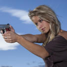 Paige takes aim with the Defender, a lighter, more compact model of the classic .45 that's her preferred personal sidearm.