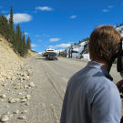 Jamie Berry, the producer-director for the first episodes of Gold Rush, films the miners' convoy along an Alaskan highway during the last leg of their journey to Porcupine Creek. Getting film crews in position at the right times along the route from Oregon to Alaska proved to be the first big challenge faced by the production team.