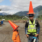 Young Hudson Hoffman and Safety Supervisor Pattrick Price can't resist a "conehead" gag. In addition to his shotgun, Pattrick used portable air horns (like the one hanging on his belt) as bear deterrents that also doubled as warning signals to alert humans when danger appeared.