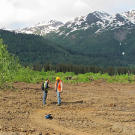 Safety Supervisor Pattrick Price has a conference with miner Safety Officer Jim Thurber about coordinating resources for bear patrols and other safety priorities. These included marking off dangerous terrain and making sure that the film crews stayed clear of equipment hazards.
