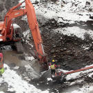 Jack Hoffman operates the excavator in the glory hole pit hoping to hit a quick jackpot. The location of the glory hole — a name given to deposits at the base of ancient waterfalls that often have high gold concentrations — was suggested by the miner on an adjacent claim. Digs at this depth typically flood so pumps are required to keep the excavation going.