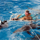 Cody's raft gives out and he's left floating on a driftwood pallet in a swarm of sharks.