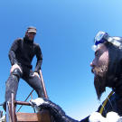 Scott prepares to help Ian back on board while he gets a report of what is down below.