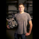 Tory Belleci poses with the customized Stormtrooper helmet he created for the 501ST TK PROJECT. Tory's Viking Helmet is one of more than 50 unique and artistically-modified Stormtrooper helmets that was displayed and auctioned off during