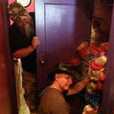 Turtleman (Ernie Brown, Jr.) and Neal James search the hair salon for potential critters.