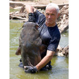 Jeremy Wade holds a flathead catfish he pulled from its underwater lair using only his hands.