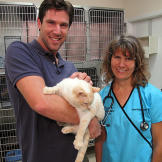 John with Dr. Carol Eddy and a beautifully striped cat.