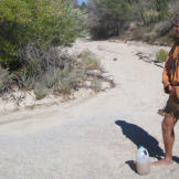 Probing for underground water sources in the most likely spots -- the lowest, well shaded parts of dry watercourses, for example -- Cody recovers a few quarts of silty water. Because it was protected in an aquifer, the water is deemed safe to drink without filtering even if it's not exactly refreshing.