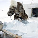 A Dolgan melts ice to obtain fresh water.