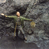 John shows off his first dig at the Big Nugget Mine in 1984. After his "retirement" a couple of years earlier, John got into gold mining almost full-time. The pit he's standing in is the result of two years of digging to reach bedrock
but there wasn't a flake of gold to be found!