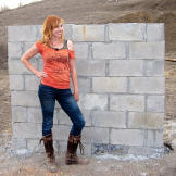 A concrete wall helps Kari Byron determine just what is truly bomb proof.