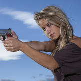 Paige takes aim with the Defender, a lighter, more compact model of the classic .45 that's her preferred personal sidearm.