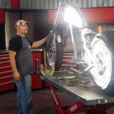 Paul Teutul Jr. regards the Anti-Venom Bike in the early days of its build — and his shop.