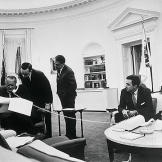 A busy scene in President Johnson's White House office shows the chief executive and his aides laboring over the budget for fiscal 1967. They are, left to right, Marvin Watson, President Johnson, Press Secretary Bill Moyers, presidential assistants Jack Valenti and Joseph Califano, Budget Director Charles Schultze, and Deputy Budget Director Elmer B. Staats.
