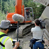 A camera team takes advantage of a brief work stoppage to film Todd at the controls of the excavator. Such intrusions were few and far between, since the production crew did everything possible to stay clear of the miners when they were working.