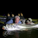 Jeremy Wade on a raft with a tarpon.