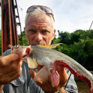 Jeremy Wade holding another victim of the piranha.