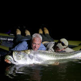 Jeremy Wade on a raft with a tarpon.